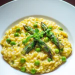 SPRING RISOTTO WITH ASPARAGUS AND PEAS centered hero view, clean and uncluttered